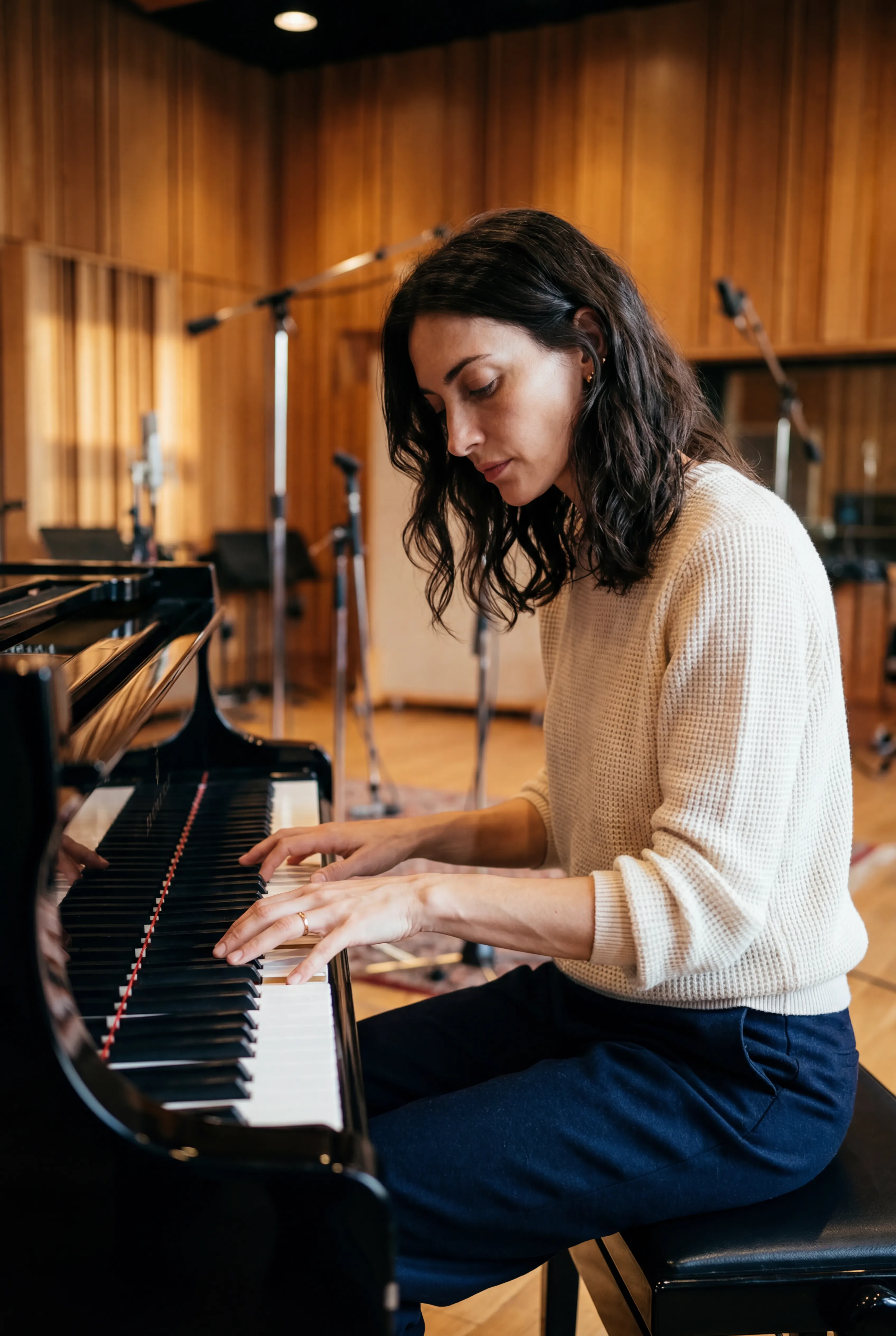Iris Lambert at a piano in a recording studio.